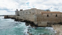 Detail of Castle of Meniace in Siracusa Ortigia Island on the sea