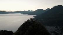 Drone aerial over Indians Nose in Lake atitlan, Guatemala during sunrise	
