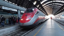 MILAN, ITALY - CIRCA JANUARY 2017: Freccia Rossa Italian high speed train departing from Milano Centrale central railway station
