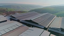 Aerial footage of large dairy farm with solar panels on the roofs