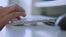 close up woman pressing the keys on keyboard entering data or communication online
