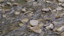 Water runs over rocks in a creek