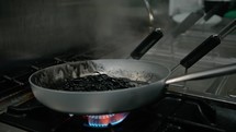 Mixing Black Italian Spaghetti In Pan With Squid Ink Of Restaurant