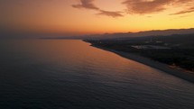 Orange Sunset Sky with coast aerial view