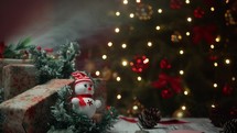 Tiny Snowman and gifts under the Christmas tree 