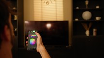 Girl change color light of the house with smart phone, home automation concept