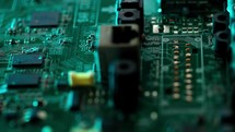 Circuit board with components. Extreme close up of green electronic board, with electronic components.

