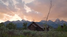 Old Wooden Chapel in the Mountains at Sunset