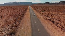 Drone is following car driving on historic route 66 through desert