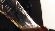 Slow motion of cold beer poured into a tall glass