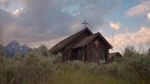 Old Wooden Chapel in the Mountains at Sunset