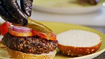 Slow motion of beef hamburger placed on a bun.