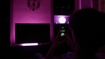 Hand of man change color light of the house with smart phone, home automation concept