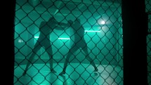 MMA fighters enter the cage ring. Mixed martial arts fight. Cinematic staged fight. 