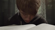 teen boy reading a BIble 
