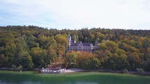 Aerial drone cinematic Schloss Seeburg Castle shoreline Lake Starnberg Munich Germany 