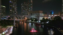 Following Shot of Yacht on Miami River Inside Downtown Miami, Florida