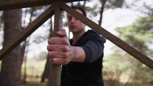 Hand Of A Man Dressed In Black Tracksuit Does Pull-ups At A Railing