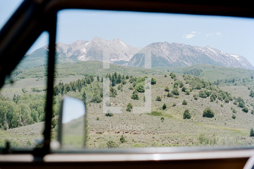view of mountains through a car window 