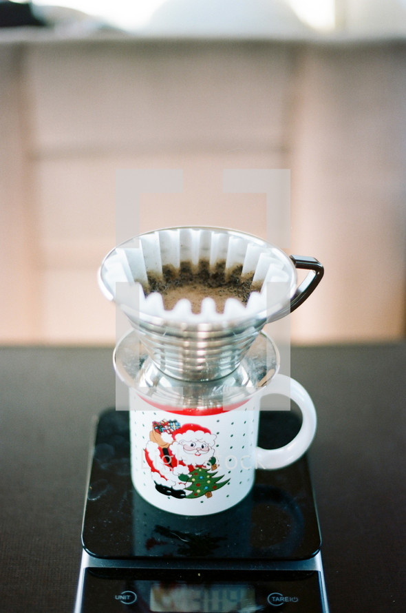 straining coffee into a santa mug 