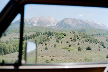 view of mountains through a car window 