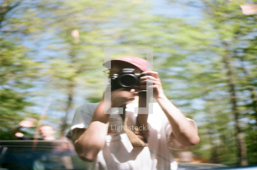 blurry image of a man holding a camera 