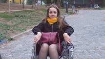 a woman in a wheelchair smiling 
