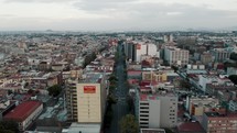 Aerial View Of Streets And Buildings In Mexico City On A Cloudy Day - drone shot	