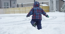 Toddler boy drops into snow