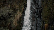 Slow Motion Of Waterfall Cascading On Rocky Cliff At The Cayambe Coca Ecological Reserve In Napo, Ecuador.