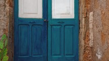 Door blue painted in rustic house in Sicily city Marzamemi