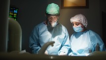 Medical staff performs complex surgical plastic breast operation