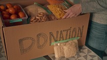 Packing up a box of food to donate