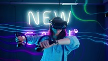 Woman moving her arms around playing a virtual reality game.