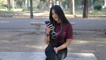 a young woman listening to music on her cellphone 