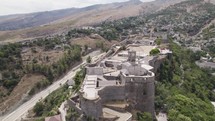Fly over Gjirokaster Fortress with beautiful view of Ottoman town, Gjirokaster Albania