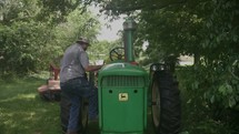 farmer getting onto a tractor 