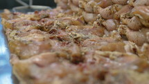 Close up of seasoned raw chicken.