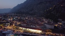 Aerial orbit shot of Kotor Cityscape during nighttime, seaside Historic city in Montenegro