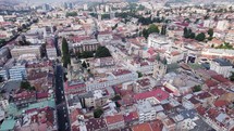 Multicultural city Sarajevo catholic, orthodox church, aerial orbit cityscape