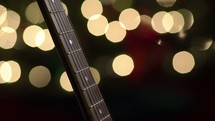guitar neck and bokeh Christmas lights 