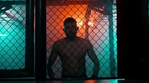 MMA fighters enter the cage ring. Mixed martial arts fight. Cinematic staged fight. 
