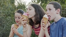 Kids eating Ice Cream together, enjoying and laughing
