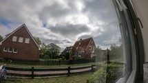 Time Lapse by the window with the clouds passing and the sun moving
