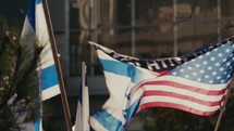 An American and Israeli flag waving in the air