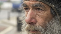 Gray bearded man on the street.