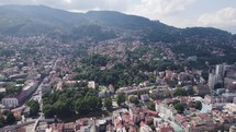 Sarajevo cityscape with dense buildings and surrounding hills. Aerial