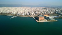 Drone shot of the coast of Greece and the Thessaloniki Concert Hall