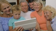 Big family watching video on touch pad