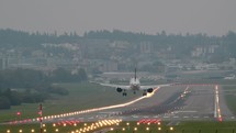 Commercial airplane landing on a runway.